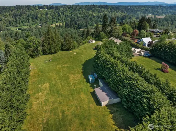Large storage outbuilding with two garage doors, breezeway to the extra storage that could easily become two horse stalls. Large storage outbuilding with two garage doors, breezeway to the extra storage that could easily become two horse stalls.