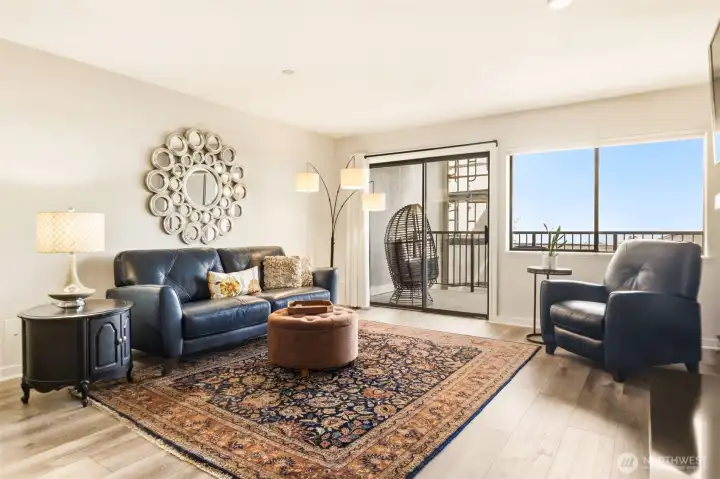 The living room is light and bright, with sliding glass door to your newly resurfaced covered deck.