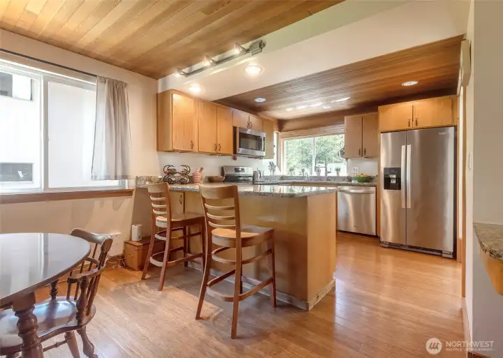 Eat in kitchen with newer stainless steel appliances and an abundance of light.