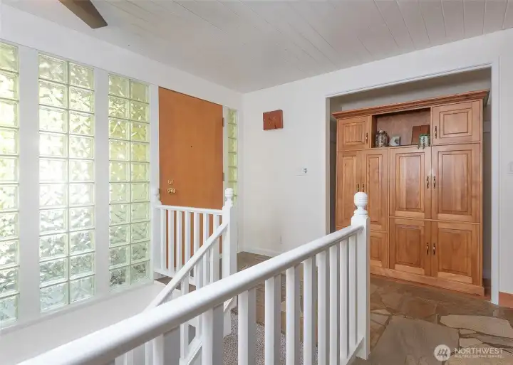 Front door with new carpet on stairs leading to the lower level.