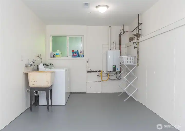 The laundry area is thoughtfully equipped with a utility sink and a newer tankless water heater for added convenience. This home is in outstanding mechanical condition, featuring a new furnace, energy-efficient tankless hot water heater, and a durable 50-year roof—providing peace of mind and long-term value for the next owner.water heater. This home is in excellent mechanical shape with a new furnace, tankless hot water heater and a 50 year roof.