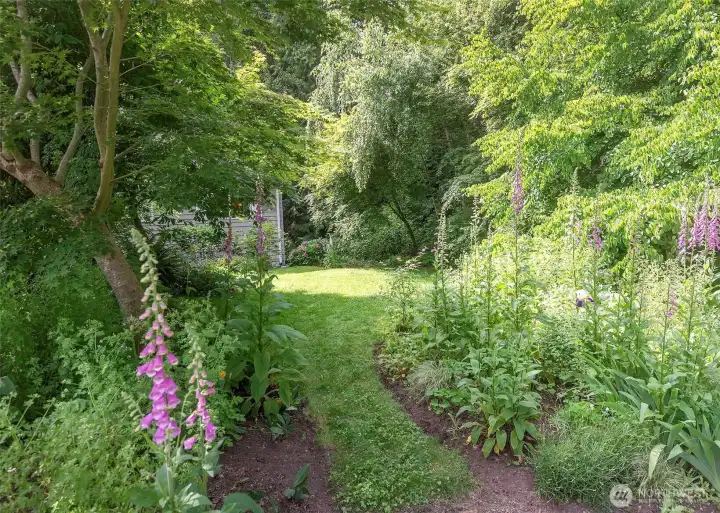 The beautifully landscaped front yard showcases an impressive collection of mature plantings that provide year-round color, texture, and interest. Thoughtfully curated over time, the gardens offer delightful surprises throughout the seasons, creating exceptional curb appeal and a warm welcome home.