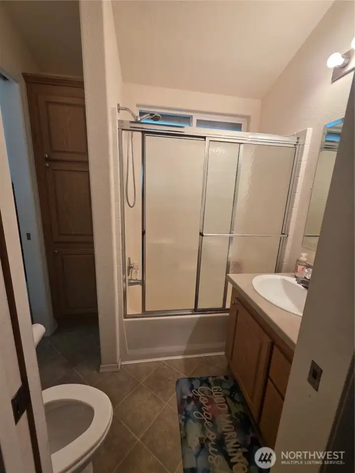 full bathroom with connecting door to bedroom
