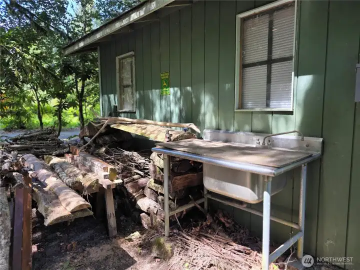 outdoor sink next to storage shed