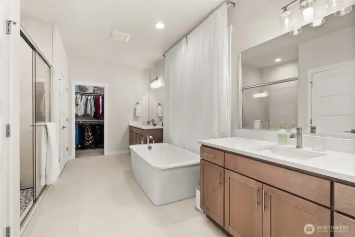 Impressive Primary En-suite with Quartz counters, tile floors, relaxing soaking tub, glass enclosed shower AND large walk-in closet Impressive Primary En-suite with Quartz counters, tile floors, relaxing soaking tub, glass enclosed shower AND large walk-in closet