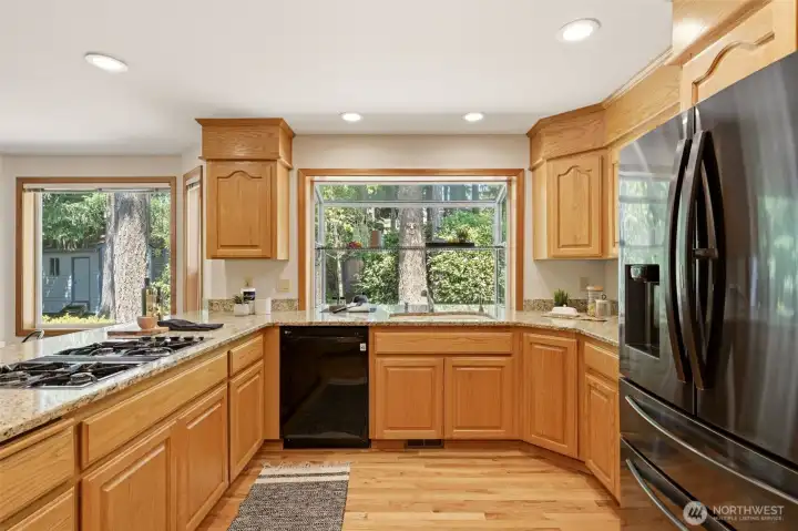 This cheerful kitchen window overlooks the private backyard. This cheerful kitchen window overlooks the private backyard.