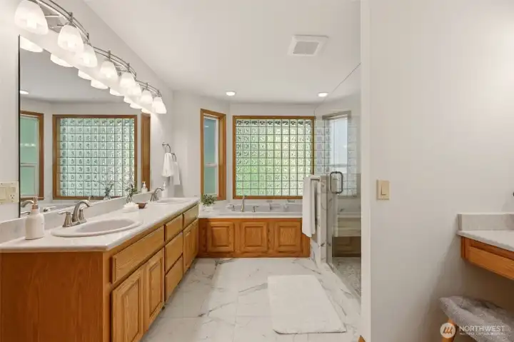 The 5 piece primary bathroom is equipped with dual sinks and a vanity table. The 5 piece primary bathroom is equipped with dual sinks and a vanity table.