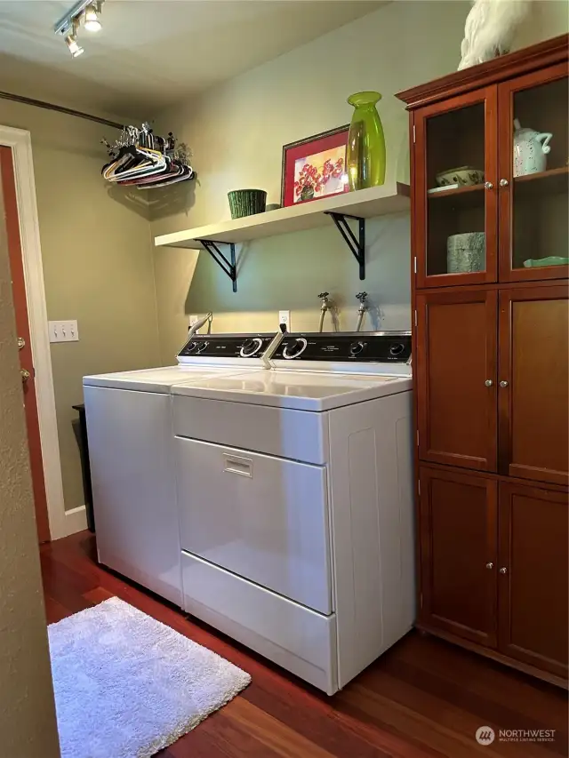 Laundry room located off kitchen and side deck with separate entry.