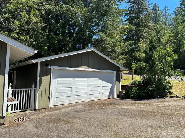 Detached large two car garage with work bench and storage .