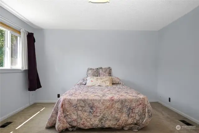 Oversized primary bedroom. Pictured is a queen size bed. Sellers prefer if the bed stays with the home.