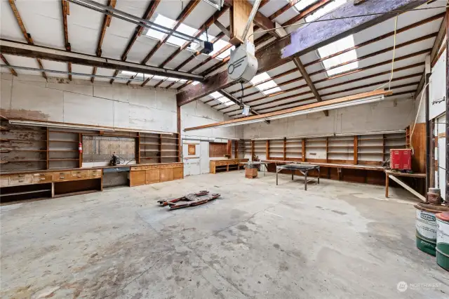 This section of the shop has lots of work space and is set up perfectly to work on vehicles or equipment. Please note the hydraulic hoist and welding table.