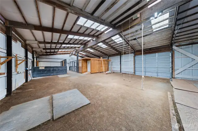 Barn with tack room and 4 stalls. Large door opens to store equipment and offloading hay.