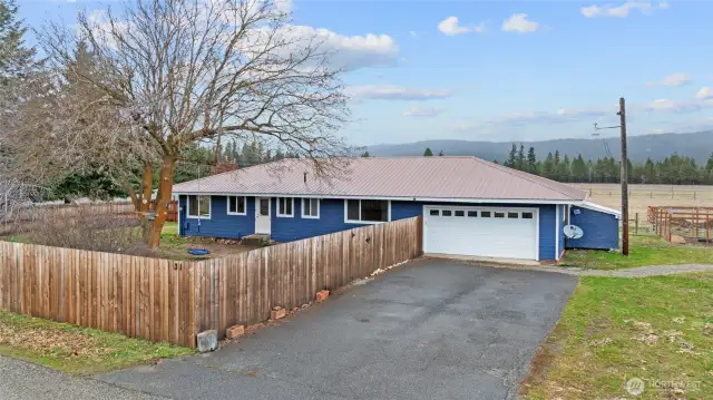 This corner farmhouse rests on 6+ acres on coveted Peoh Point. Minutes to town, but gorgeous rural location. Fully fenced front yard!