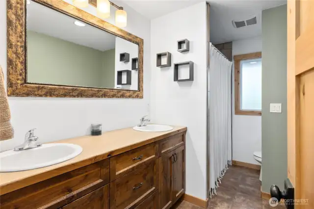 The full bath features tile floors & double sinks!
