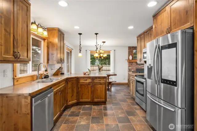 This well appointed farmhouse kitchen has custom cabinets, solid surface counters, & stainless steel appliances!