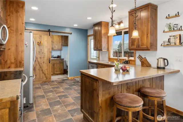There is bar seating off the kitchen in addition to the dining space.