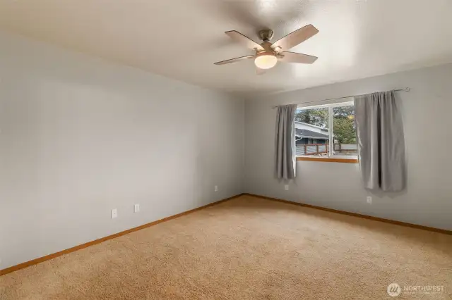 Another view of the primary bedroom. This window faces out to backyard that is fully fenced.