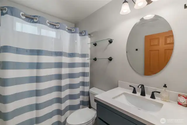 Hallway bathroom with tub/shower combo. Newer sink/cabinet as well as new updated faucet.