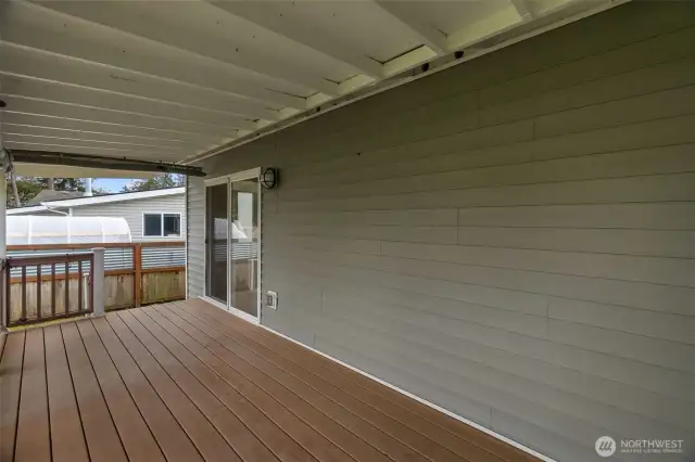 Another view of the covered back patio. This slider enters into a small dining area.