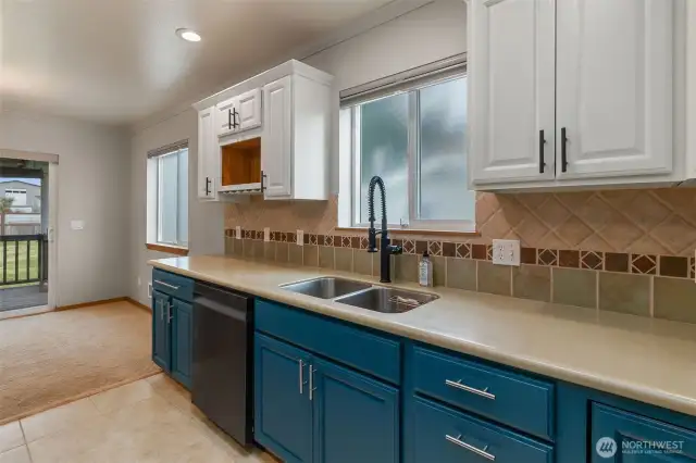 Corian counters with tall tile backsplash.