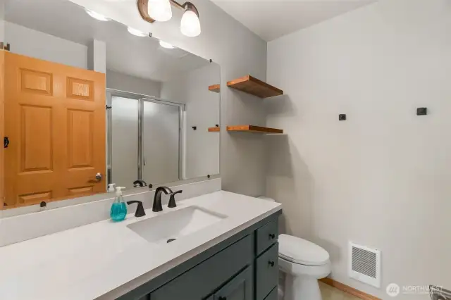 Primary bathroom with updated cabinet and sink.