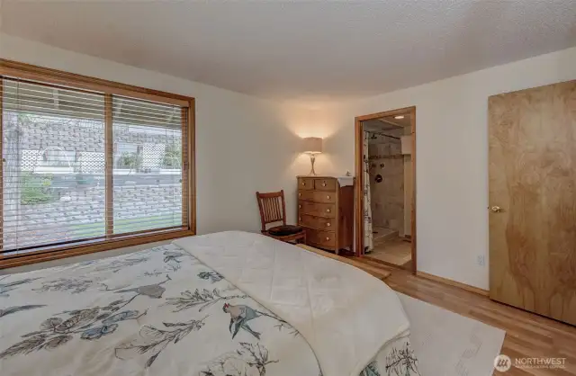 Primary bedroom has a very large window and a well-appointed attached bathroom