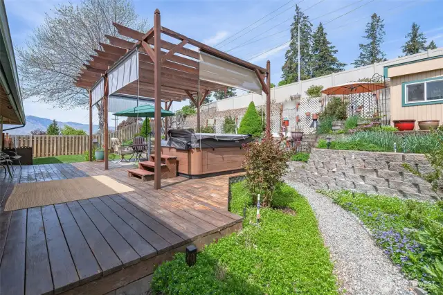 Can you say OASIS?? This backyard has it all...sprawling cedar deck, pergola with shades, manicured gardens, and a shop-shed!
