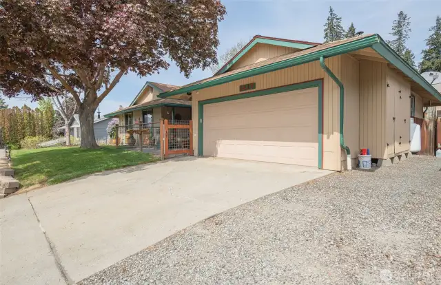 Concrete driveway plus a large gravel strip for your toys!