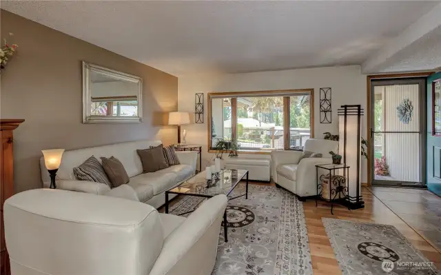 Living room with warm tones, bay window and wood fireplace