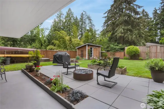 Wonderful flat fenced backyard with gas fire pit and wood fire ring.