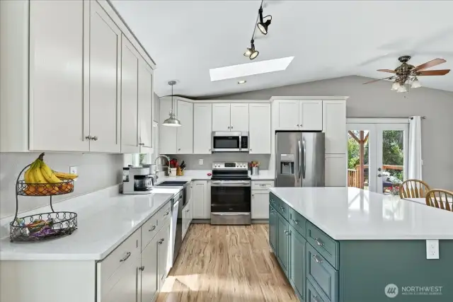 New kitchen with granite slab island, cabinets, & appliances