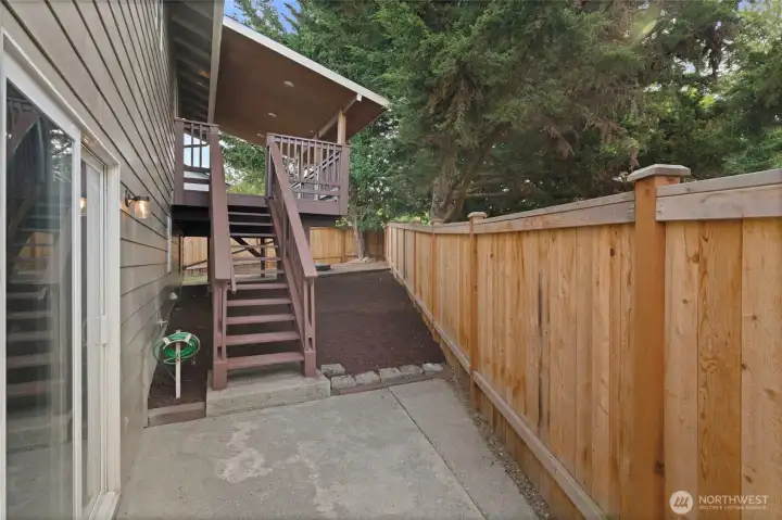 Steps leading up to covered deck in backyard.