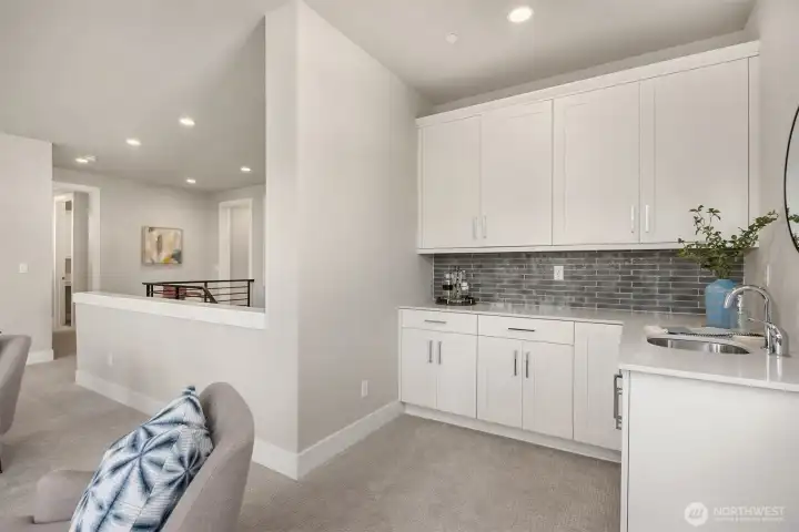 Upper level family room with bar and snack area. Perfect for game night!