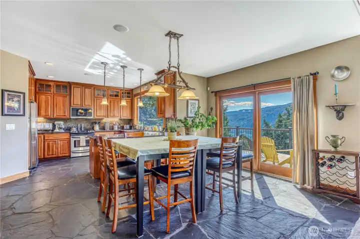 Dining area features S. African Slate flooring & a full sliding door to the wrap around deck. Lake views from every room all year long! Open floor plan flows easily from living area to the kitchen.