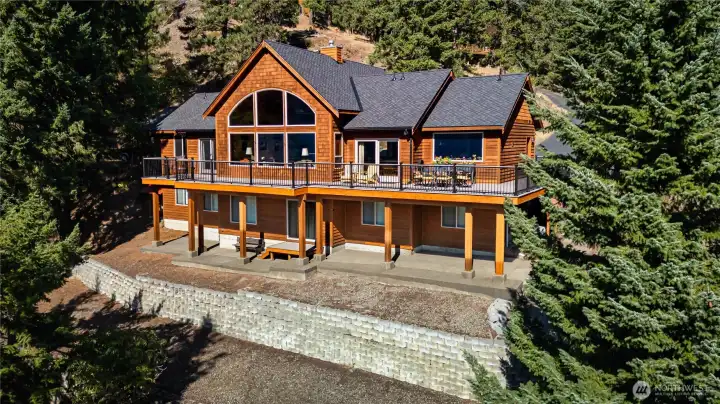 View of home from the lake side. Patio & deck take full advantage of the lake & mountain views.