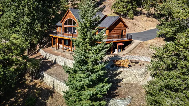 Terraces below the patio are a great spot for raised garden beds. Firepit area to enjoy year around.