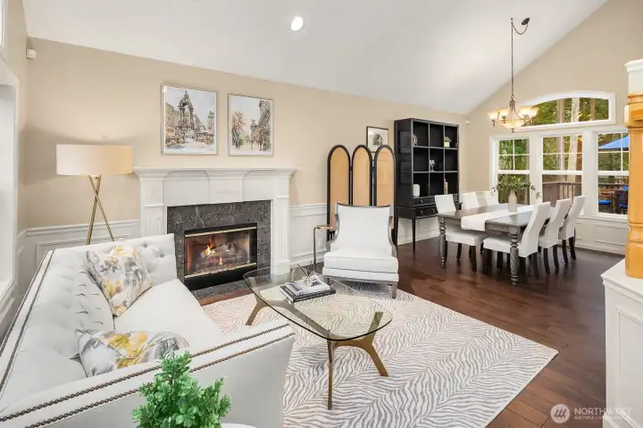 Vaulted ceilings and large windows fill the home with natural light, creating a warm and inviting atmosphere throughout.