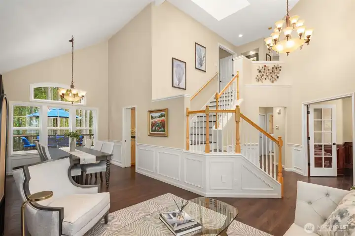 The main level includes a living room, formal living room, kitchen, and dedicated office—all connected with seamless flow.