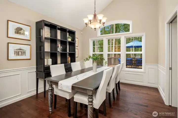 Beautiful dinning room overlooking the patio and verdant back yard.