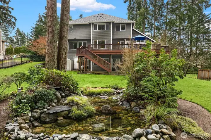 Step outside to a beautiful, fully fenced backyard with a tranquil fountain—perfect for morning coffee, play, or entertaining—set within the natural surroundings that define the Leota neighborhood.