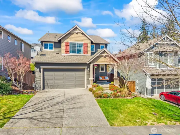 Attractive Skagit Highlands home with inviting curb appeal, covered front porch, and landscaped yard.