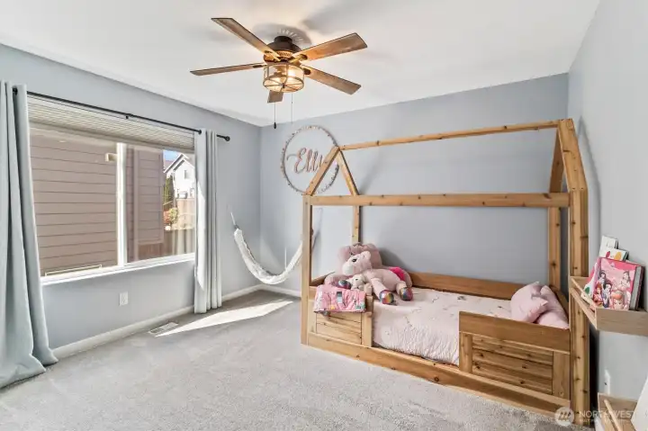 Secondary bedroom with large window and natural light.