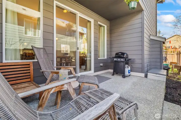 Covered side patio perfect for outdoor seating and grilling.