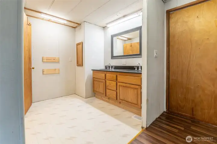 Primary en-suite with stone countertop and solid wood cabinet