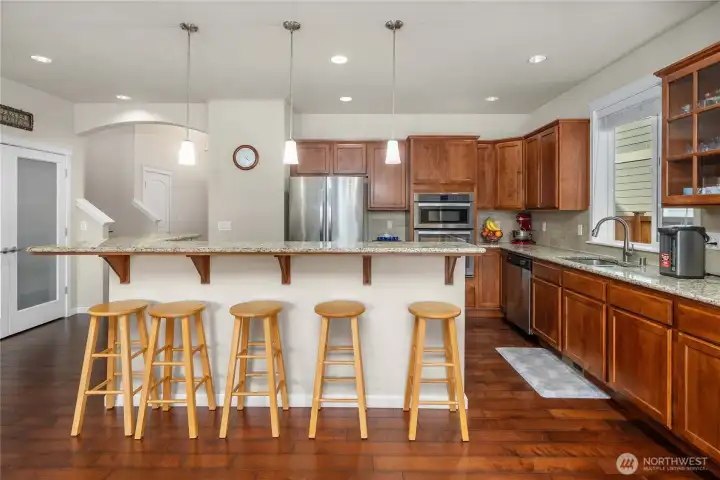 Entertainer’s kitchen showcases a large center island with seating, abundant cabinetry, and an ideal layout.