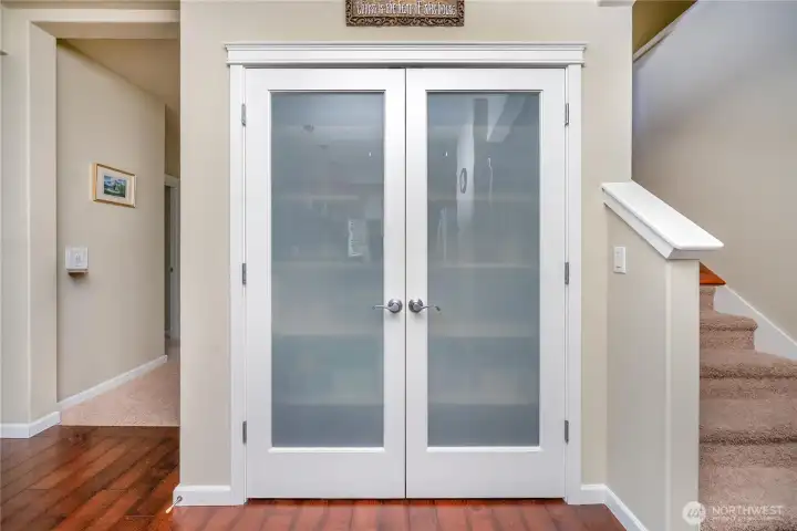 Conveniently located pantry with double doors offers easy access and additional storage for everyday essentials.