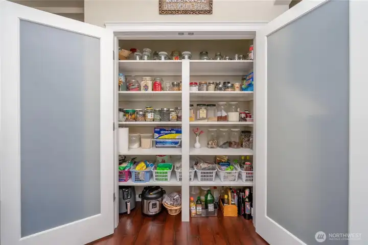 Spacious pantry with built-in shelving keeps everything organized and easily accessible