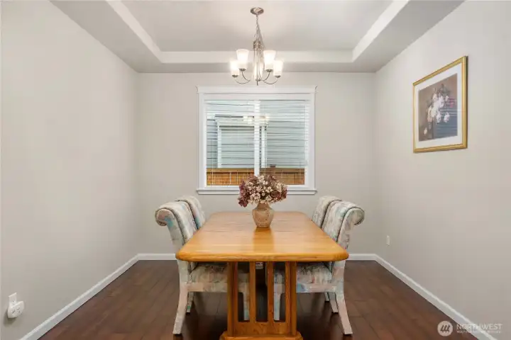 Formal dining room with elegant coffered ceiling, ideal for hosting gatherings or special occasions.