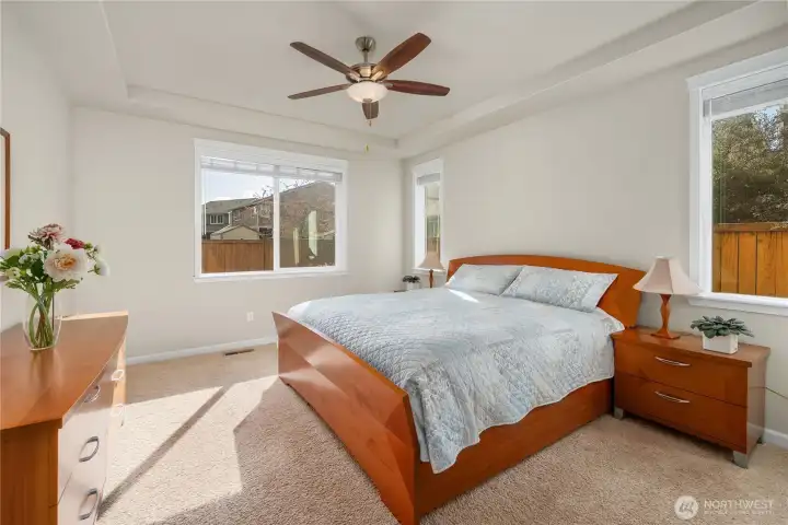 Private primary suite on the main level, located in its own wing of the home.