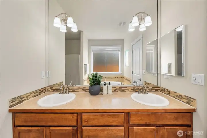 Primary bath features a dual vanity w/storage, full sized mirror & medicine cabinet.